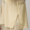 Ellie Button Up showing side slit and part of hem with yellow and white thin stripes on lightweight fabric