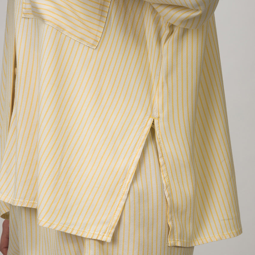 Ellie Button Up showing side slit and part of hem with yellow and white thin stripes on lightweight fabric