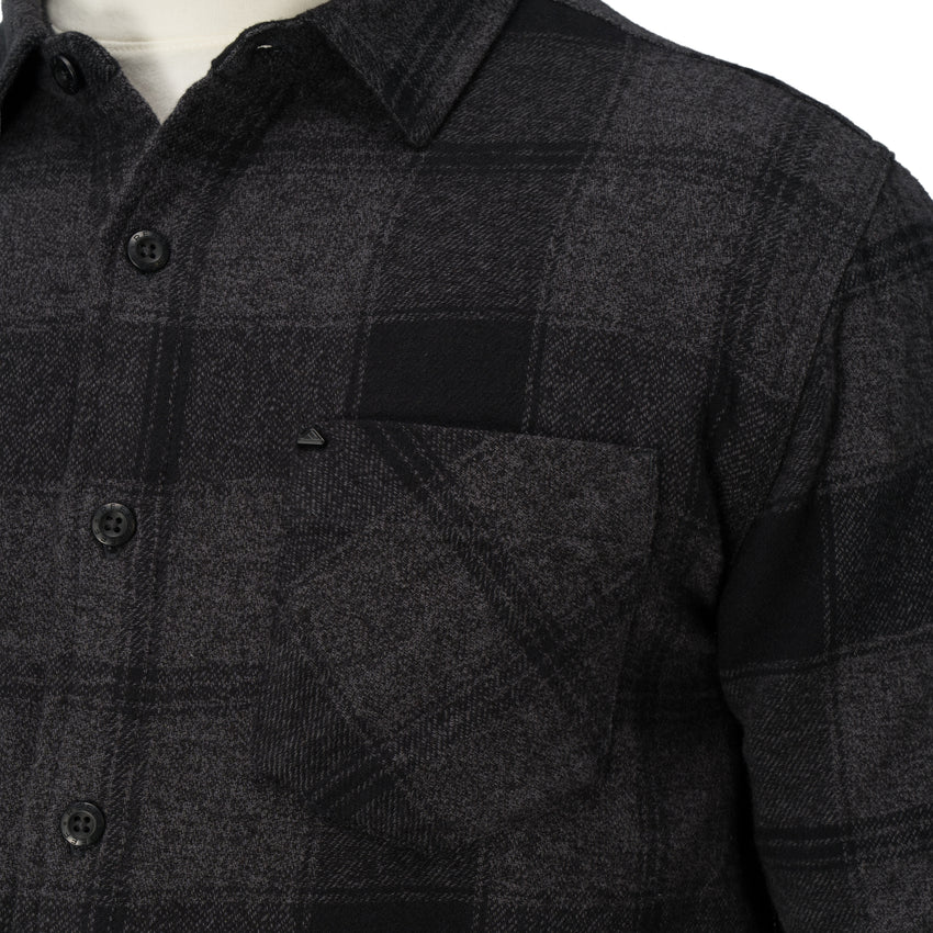 Close-up of the chest pocket and buttons on the Reggie Flannel Shirt in dark gray plaid from StoreRank.ai All Products.