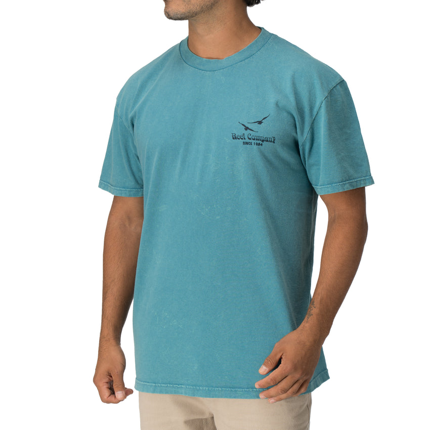 Man wearing a blue Kyle Short Sleeve Tee with a relaxed fit, vintage surf-inspired design, front view, StoreRank.ai All Products