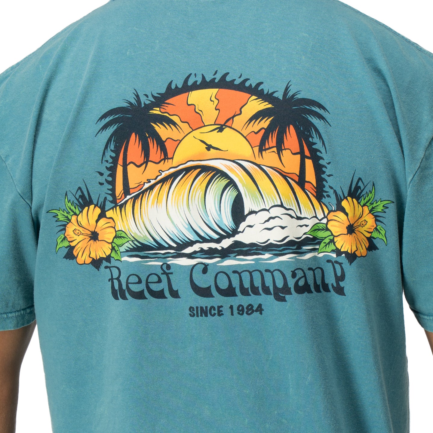 Back view of Kyle Short Sleeve Tee in sun-faded blue with vintage surf wave and palm tree graphic for beach comfort.