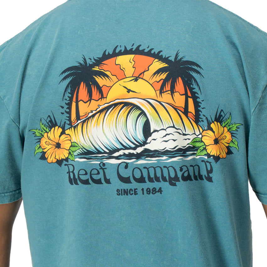 Back view of Kyle Short Sleeve Tee in sun-faded blue with vintage surf wave and palm tree graphic for beach comfort.
