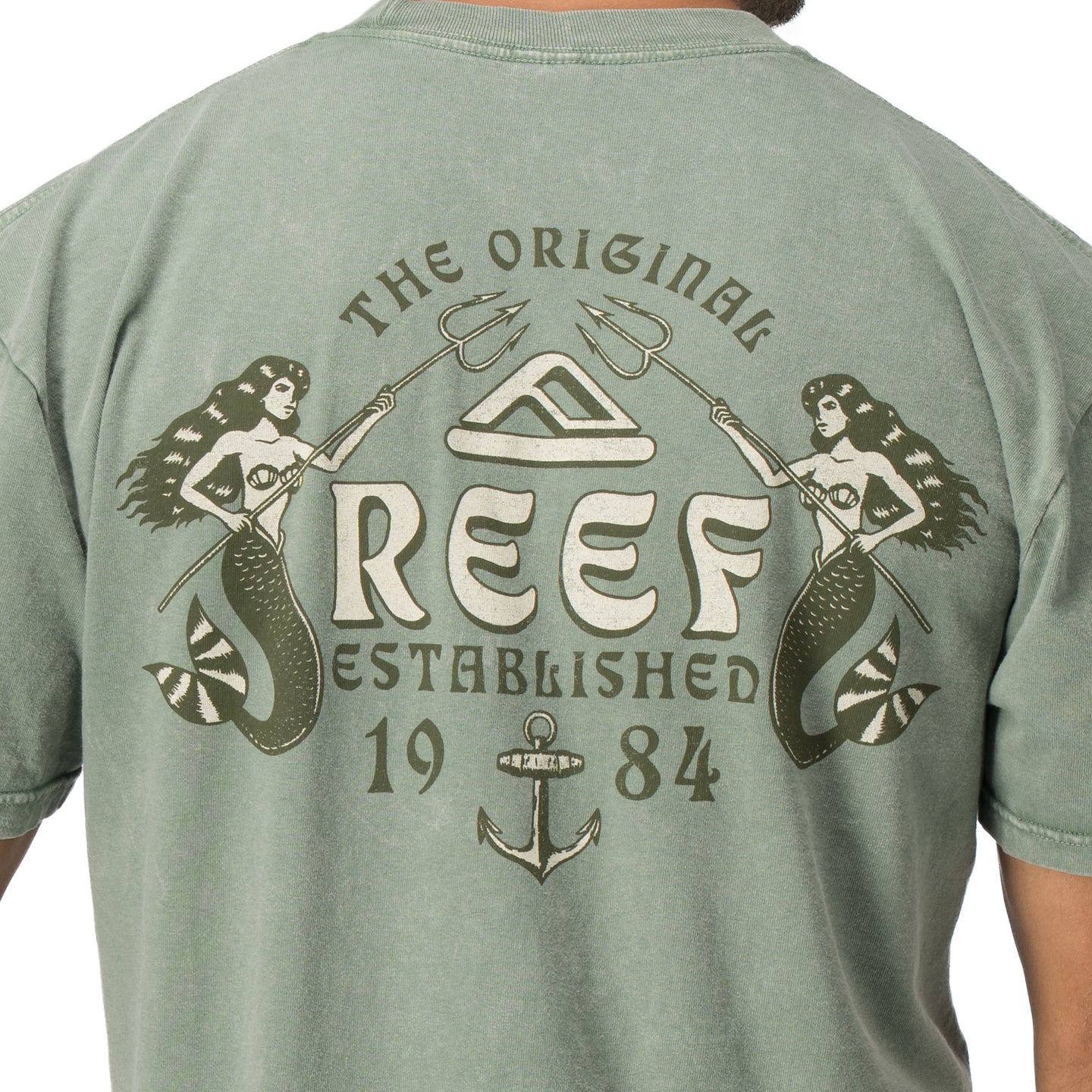 Back view of Twining Short Sleeve Tee featuring vintage Reef logo with mermaids and anchor on faded green fabric.