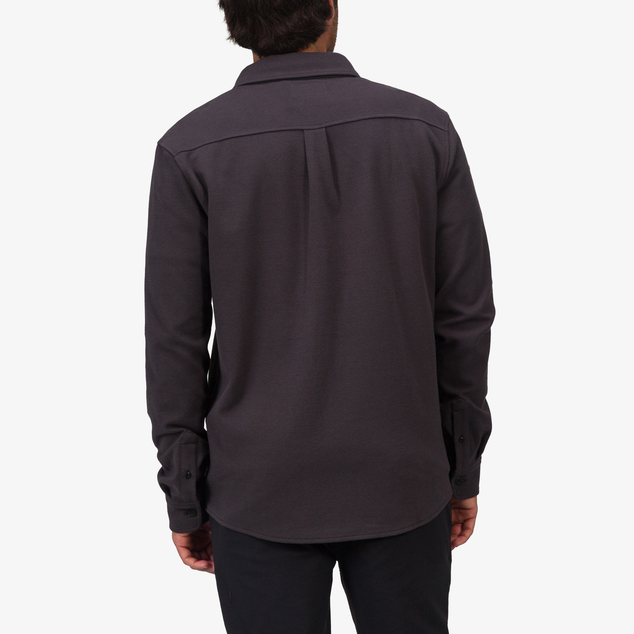 Back view of a man wearing the Raymond Ls Shirt in dark gray, showcasing its casual, surf-inspired comfortable apparel style.
