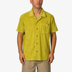 Man wearing a mustard yellow Myran Camp Shirt with short sleeves and vertical stripes, front pocket visible, standing straight.