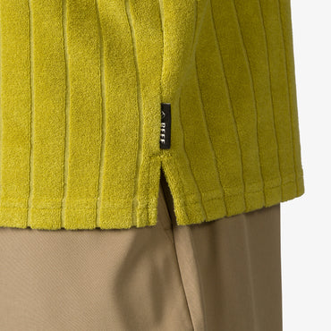 Close-up of the hem and side slit of the Myran Camp Shirt in olive green, highlighting textured ribbed fabric.