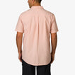 Man wearing a light pink Collins Ss Woven Shirt showing the back, casual beach-inspired men’s apparel