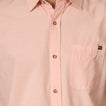 Close-up of a light pink Collins Ss Woven Shirt showing front buttons and chest pocket with surf-inspired design.