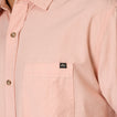 Close-up of the chest pocket on the Collins Ss Woven Shirt in soft pink, highlighting comfort and quality stitching.