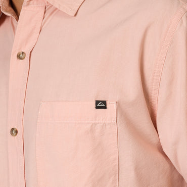 Close-up of the chest pocket on the Collins Ss Woven Shirt in soft pink, highlighting comfort and quality stitching.