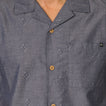 Close-up of the chest area on the Harold Camp Shirt in blue with patterned fabric and wooden buttons.