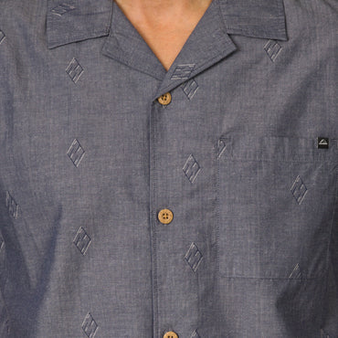 Close-up of the chest area on the Harold Camp Shirt in blue with patterned fabric and wooden buttons.