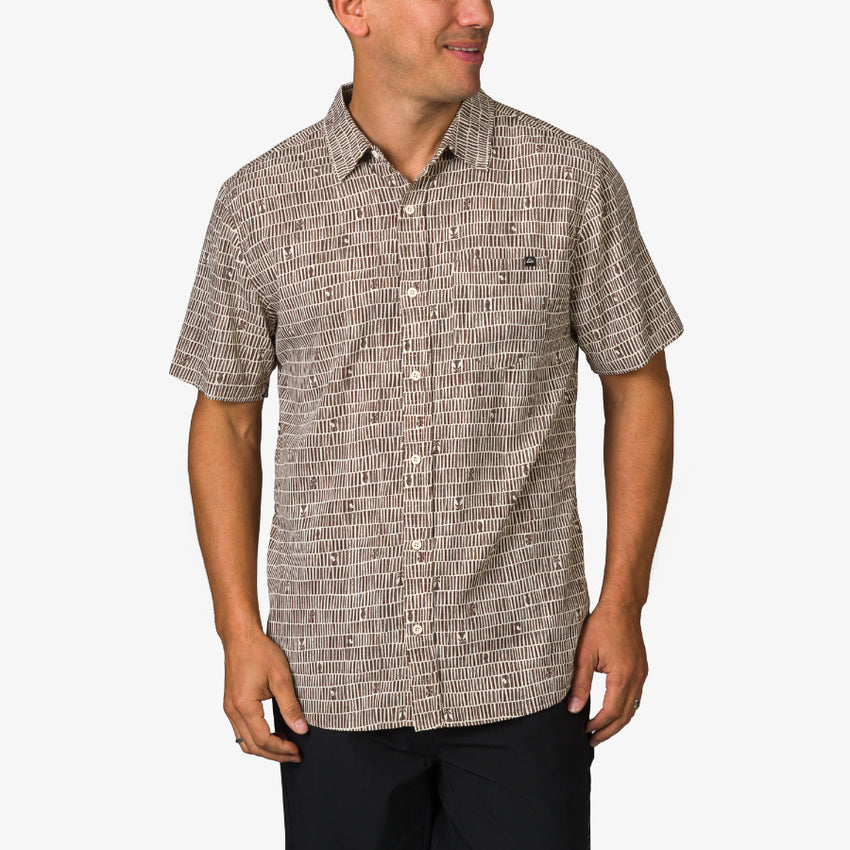 Man wearing Ferris Classic Shirt with beige geometric pattern, front view, styled for beach comfort and active lifestyle.