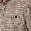 Close-up of chest pocket on Ferris Classic Shirt in brown patterned fabric, designed for men's beach-inspired comfort apparel.