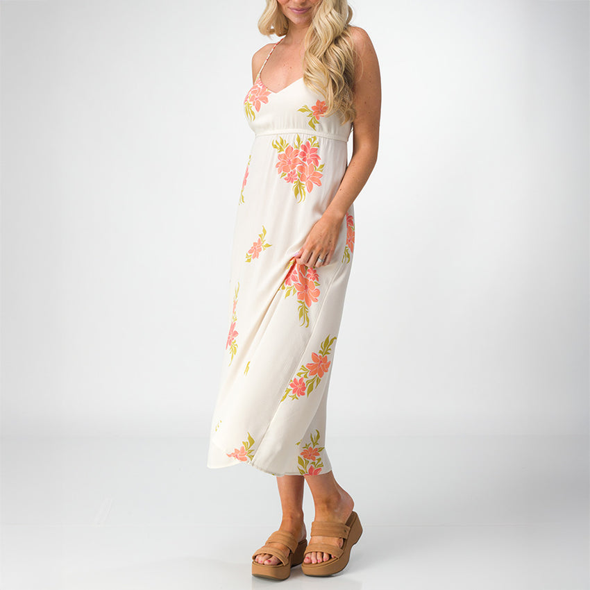 Woman wearing Belladona Dress with floral print and tan platform sandals, facing front in a relaxed beach style pose