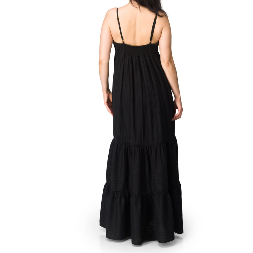 Woman wearing Yuni Maxi Dress shown from back, lightweight breathable black cotton fabric, relaxed fit for beachwear.