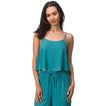 Woman wearing a teal Ollie Tank with thin straps, designed for comfort and a beach-inspired active lifestyle.
