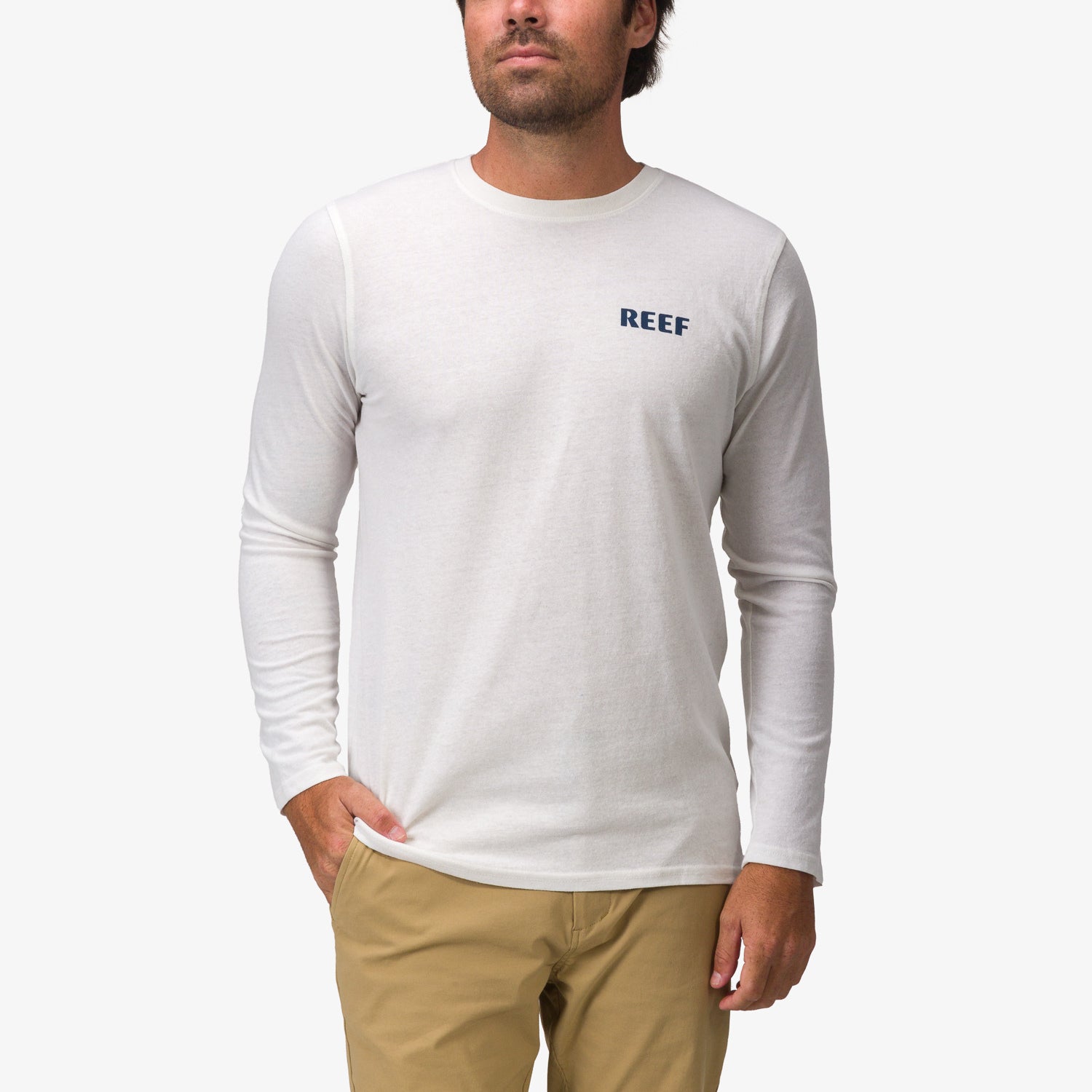 Man wearing a white Wellie 24 Long Sleeve Tee facing front, surf-inspired comfort and durable beach apparel design.