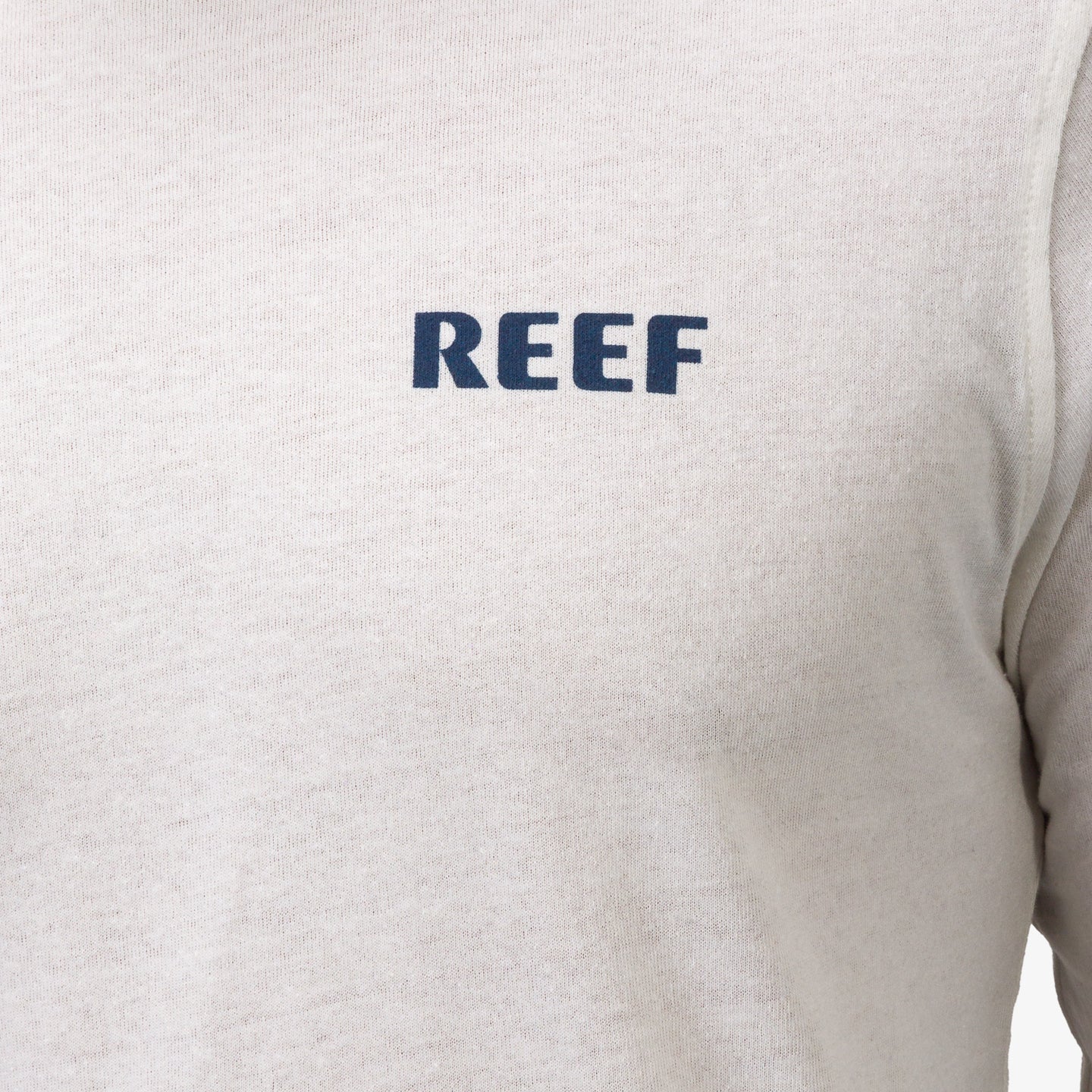 Close-up of the front chest logo on the Wellie 24 Long Sleeve Tee, surf-inspired comfort apparel by REEF.