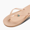 Kids Charming flip flop facing right, close-up of footbed and transparent thong strap with small wave logo detail