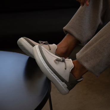 Side view of Rambler men's shoes in oatmeal, showing comfort-driven design with arch support and cushioned soles.