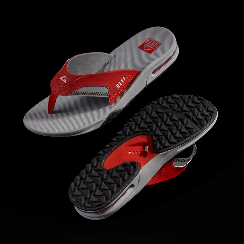 Pair of Fanning Pregame sandals for men with red and grey straps, showing top and textured sole, beach inspired comfort.