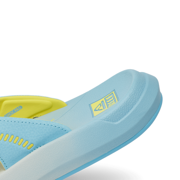 Close-up of the left front side of the Cruiser sandal in light blue and yellow, showing cushioned sole and arch support.