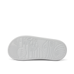 Kids Rio Slide outsole facing up showing textured beach-inspired sole with palm tree and wave patterns in light grey