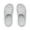 Kids Rio Slide sandals in light grey, top view showing open toe and cushioned, water-friendly design facing upward.