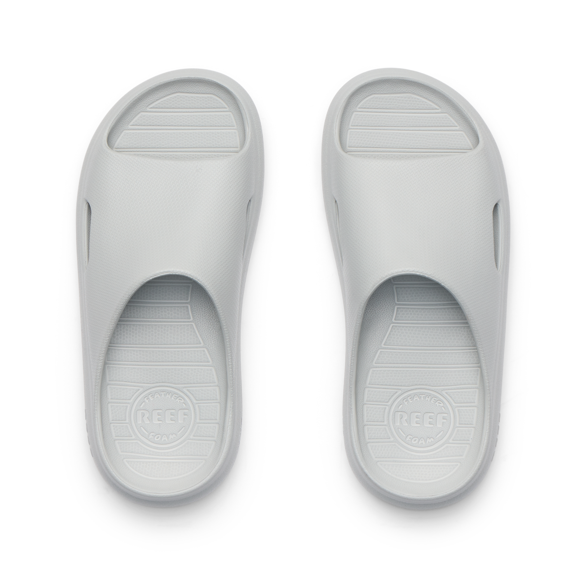 Kids Rio Slide sandals in light grey, top view showing open toe and cushioned, water-friendly design facing upward.