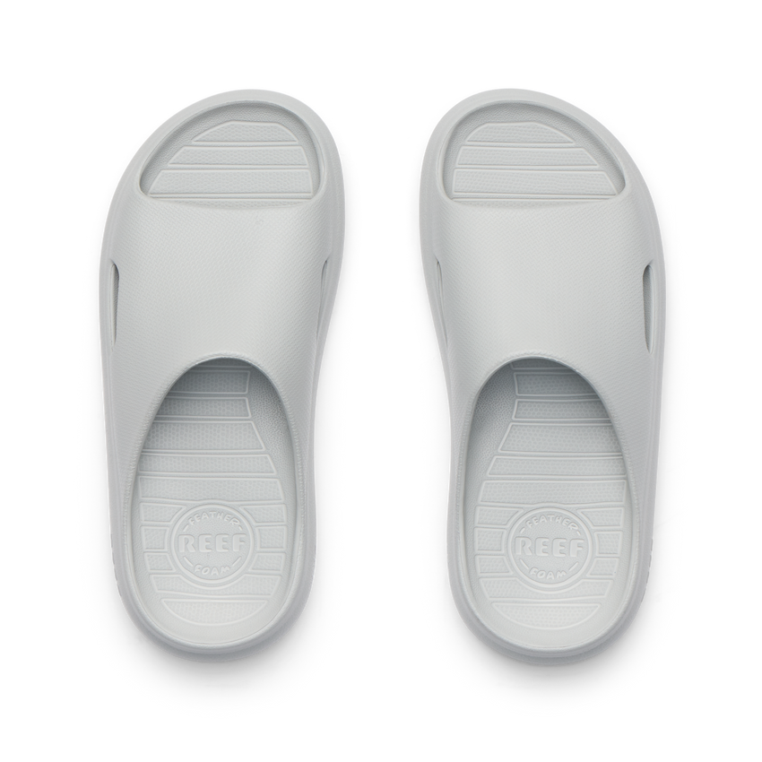 Kids Rio Slide sandals in light grey, top view showing open toe and cushioned, water-friendly design facing upward.