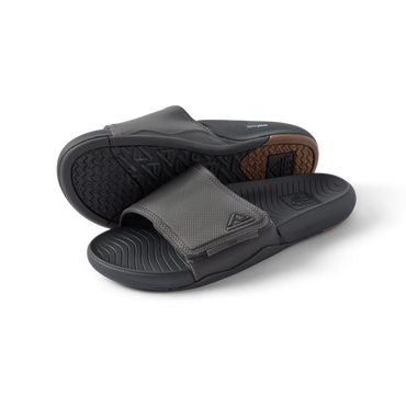Pair of men's Phantom Slab slides in black facing forward, showing soft-rebound cushioning and anatomical arch support.