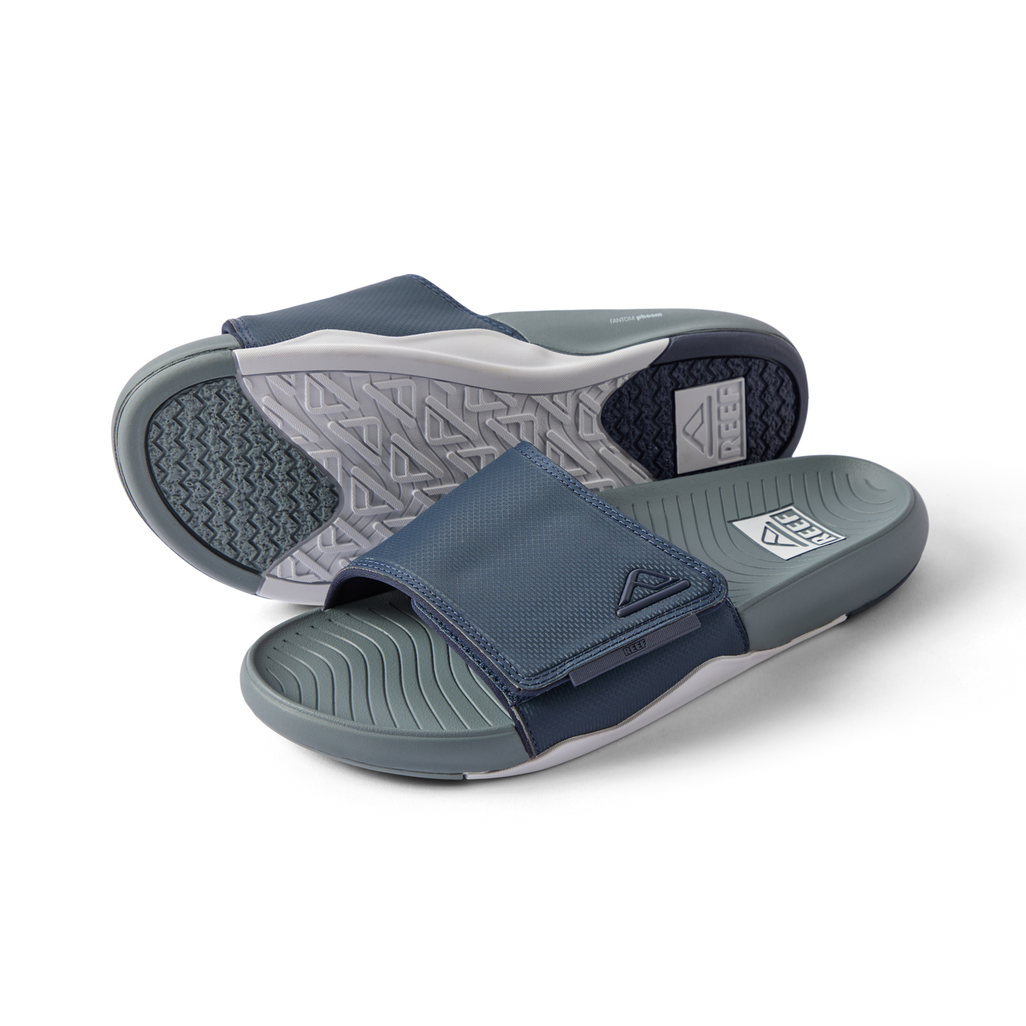 Phantom Slab men's slide sandals facing left with breathable navy grey straps and cushioned footbeds for beach comfort.