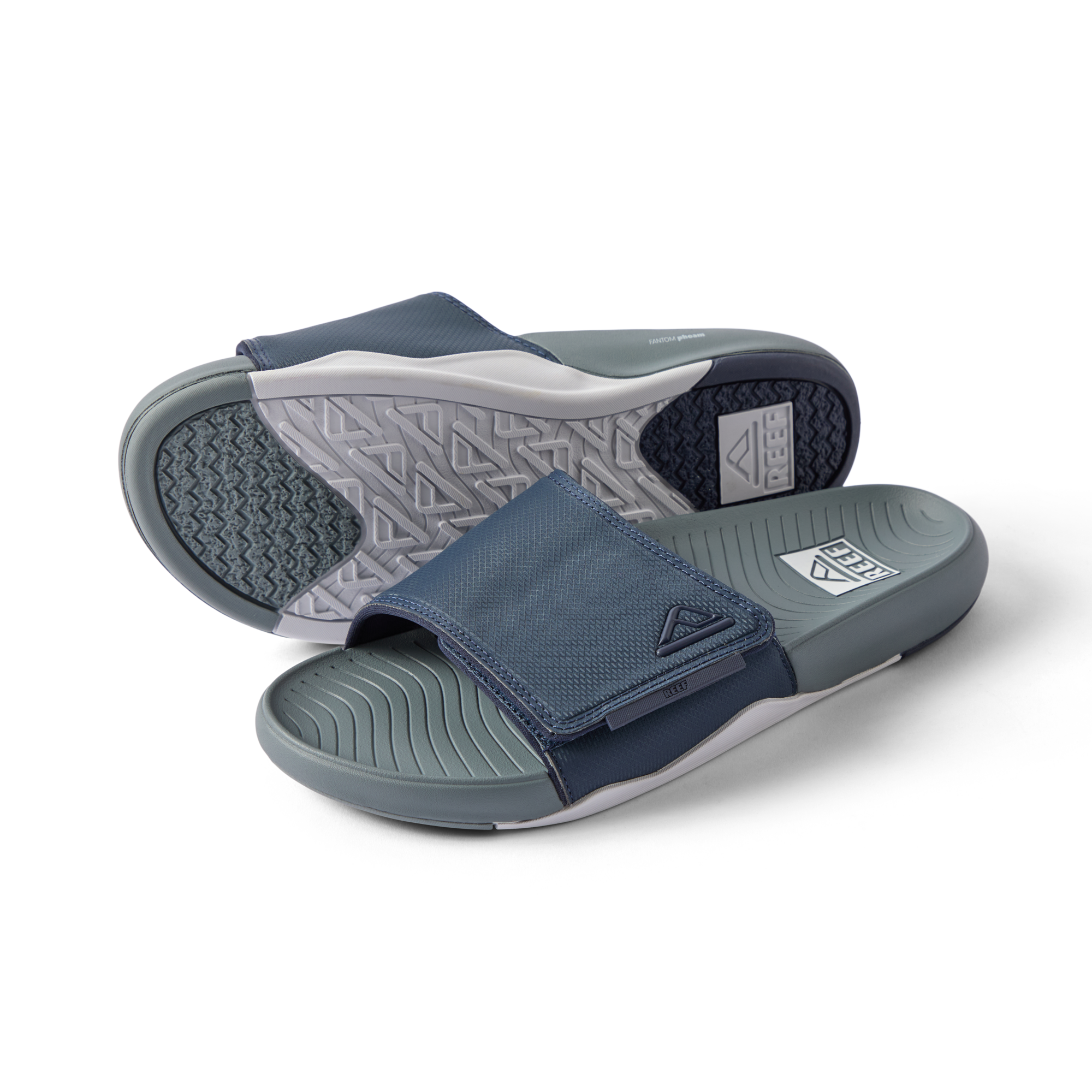 Phantom Slab men's slide sandals facing left with breathable navy grey straps and cushioned footbeds for beach comfort.