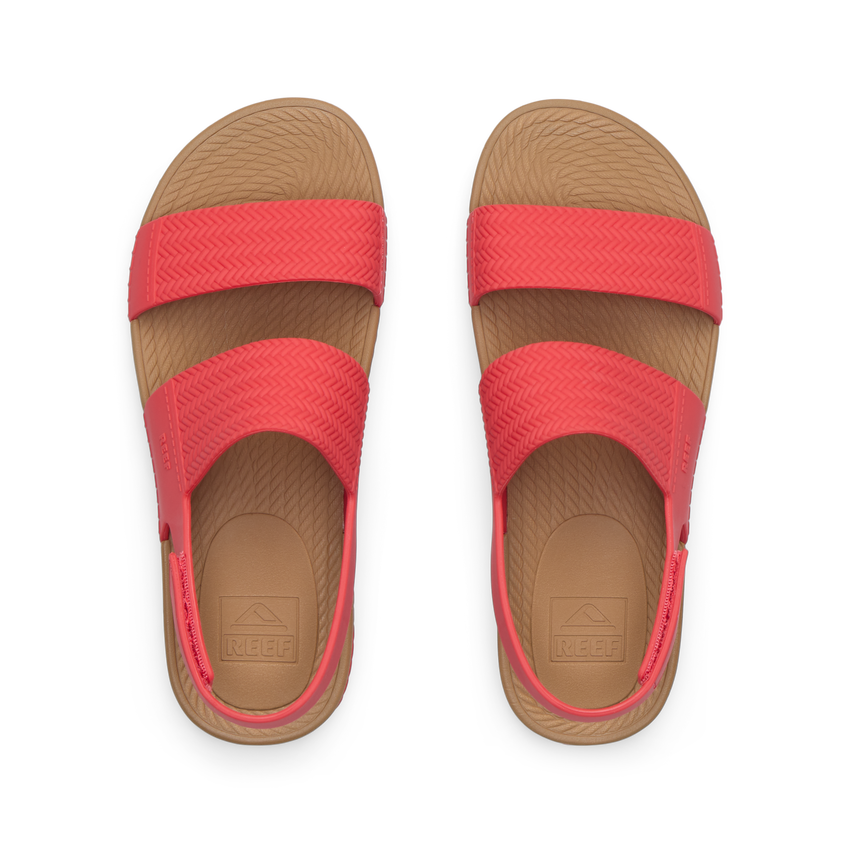 Top view of women's Reef Water Vista coral sandals with arch support and cushioned footbeds, designed for beach comfort.