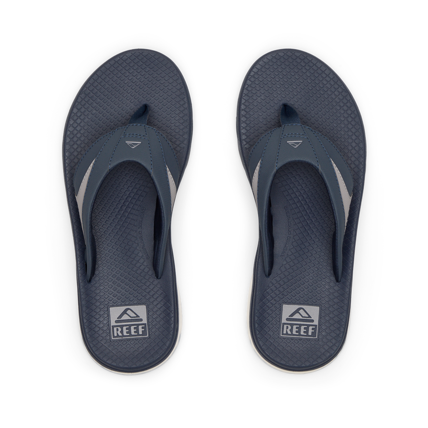 Pair of men's Fanning + flip flops facing upward, navy and grey, with anatomical arch support and cushioned footbeds