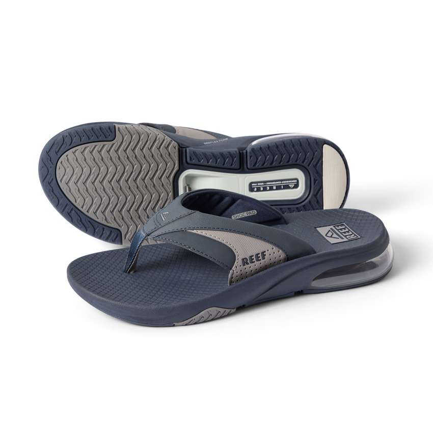 Fanning + men’s navy gray flip flops, angled left showing top and sole, comfort cushioning and arch support