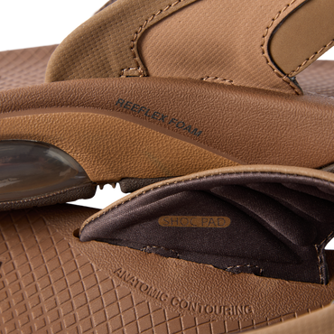 Close-up of the side and inner strap of the Fanning + sandal showing cushioning and shock pad details facing left.