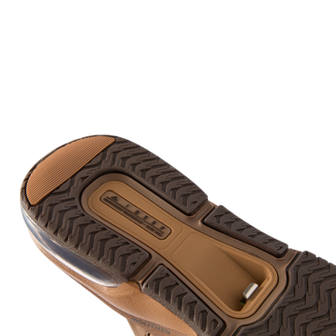 Fanning + men's shoe sole facing up, showing durable tread and comfort-focused cushioning with arch support features.