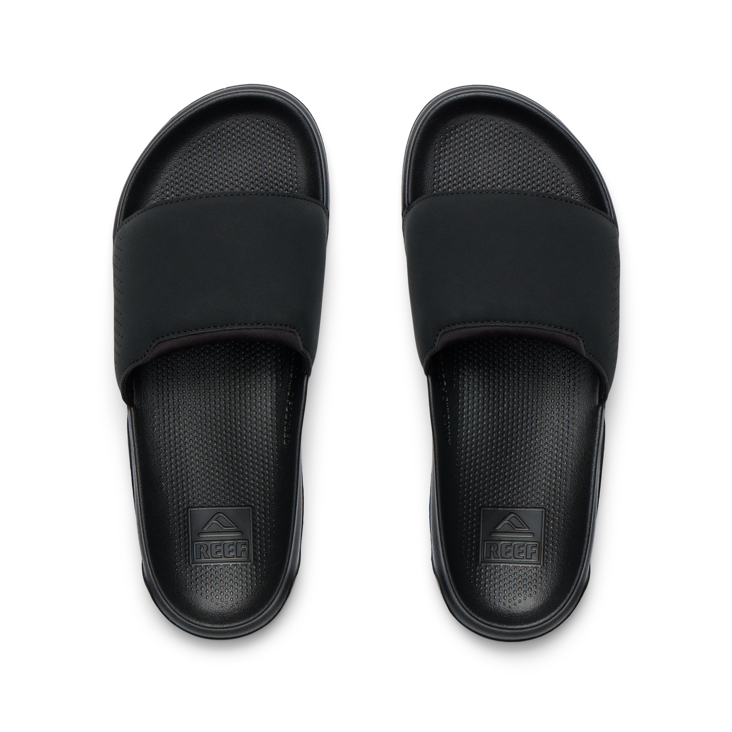 Tailslide men's black slides facing up, close-up of footbeds with textured cushioning and arch support for water-friendly comfort.