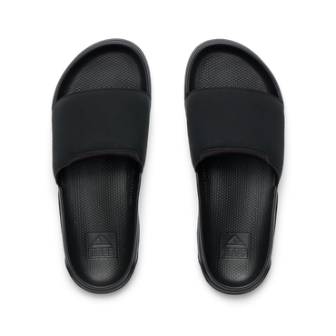 Tailslide men's black slides facing up, close-up of footbeds with textured cushioning and arch support for water-friendly comfort.