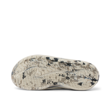 Glider sandal outsole facing up with textured tread in beige and black, showing durable water-friendly sole design