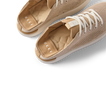 Reef Neptune women's shoes facing left with close-up on cushioned insoles and breathable knit upper in metallic gold.