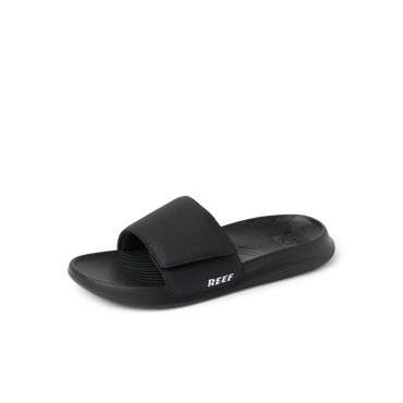 Kids Salty Slide in black facing left, close-up of the top and side showing cushioned footbed and adjustable strap.