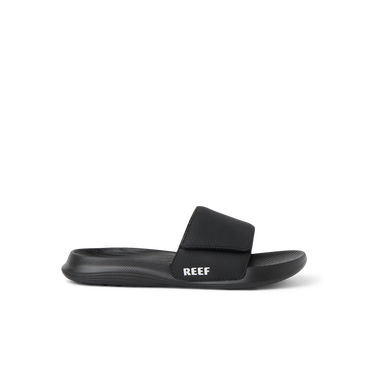 Kids Salty Slide black right-facing side view showing soft-rebound cushioning and anatomical arch support in a beach-inspired slide.