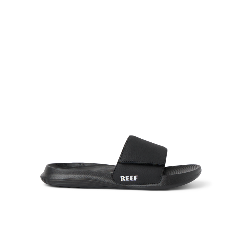 Kids Salty Slide black right-facing side view showing soft-rebound cushioning and anatomical arch support in a beach-inspired slide.