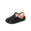 Little Totally Beachin left-facing kids sandal in black and tan with pink strap, showing front and side for beach comfort.