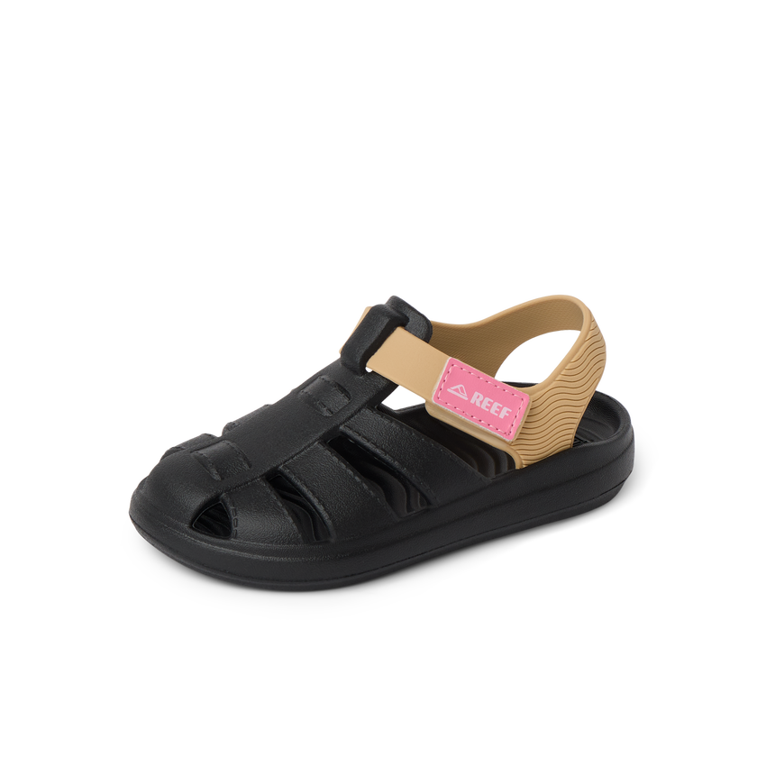 Little Totally Beachin left-facing kids sandal in black and tan with pink strap, showing front and side for beach comfort.