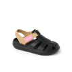 Little Totally Beachin girls sandal facing left, black and tan with arch support and soft cushioning for beach comfort.