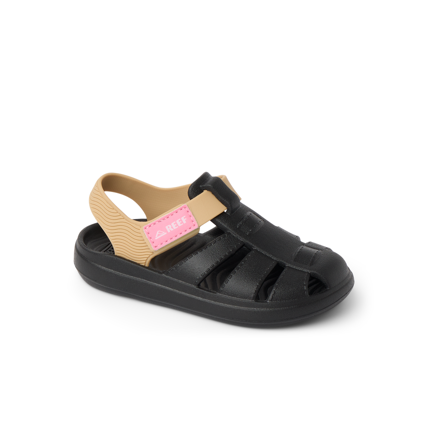 Little Totally Beachin girls sandal facing left, black and tan with arch support and soft cushioning for beach comfort.